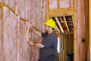 Contractor installing insulation